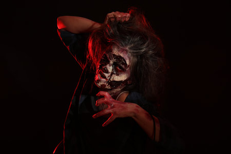 Scary zombie on dark background. Halloween monster