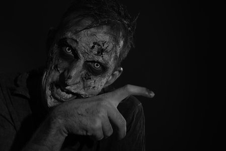 Scary zombie on dark background, black and white effect. Halloween monsterの写真素材