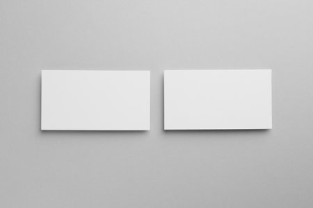 Blank business cards on light gray background, top view. Mockup for designの写真素材