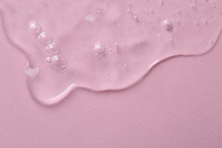 Cosmetic serum on pink background, top view. Space for textの写真素材