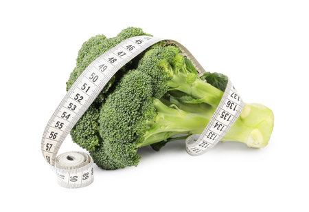 Healthy diet. Broccoli with measuring tape isolated on whiteの写真素材