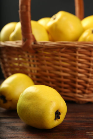 Basket with delicious ripe quinces on wooden table, closeupの写真素材