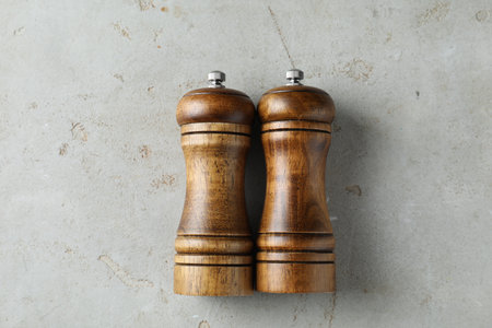 Wooden salt and pepper shakers on light textured table, top viewの写真素材
