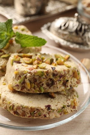 Tasty halva with pistachios and mint on table, closeupの写真素材