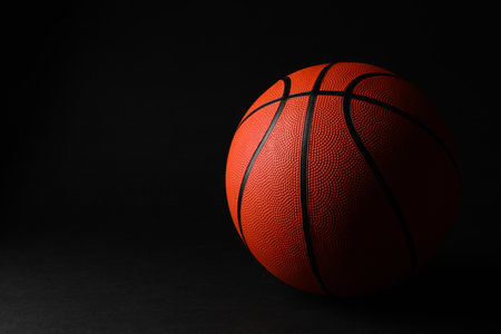 One basketball ball on black background. Space for textの写真素材