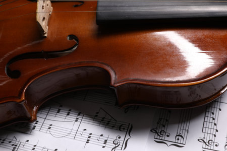 Classic violin on music sheets, closeup viewの写真素材