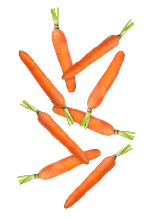 Fresh ripe carrots falling on white backgroundの写真素材