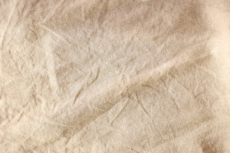 Beautiful beige fabric as background, top viewの写真素材
