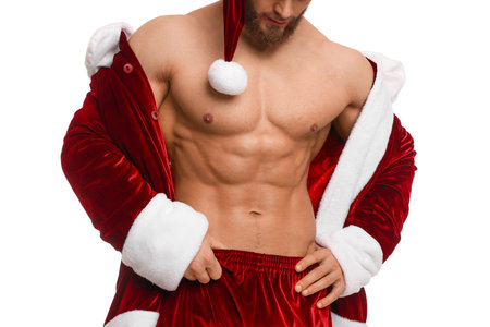 Young man with muscular body in Santa costume on white background, closeupの写真素材