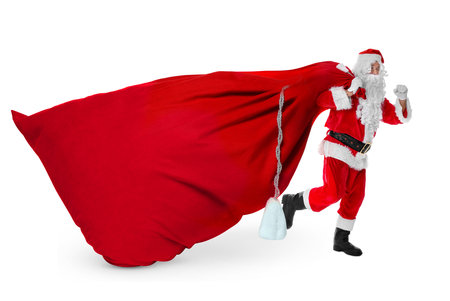 Santa Claus with big red bag full of Christmas presents on white backgroundの写真素材
