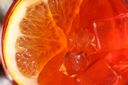 Aperol spritz cocktail, ice cubes and orange slice in glass, closeupの写真素材