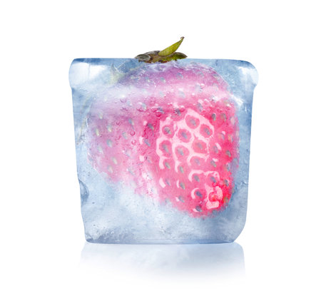 Frozen food. Raw strawberry in ice cube isolated on whiteの写真素材