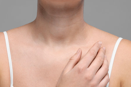 Closeup view of woman with normal skin on gray background