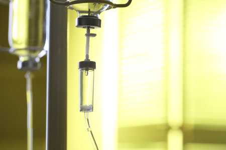 IV drip against blurred yellow background, space for textの写真素材