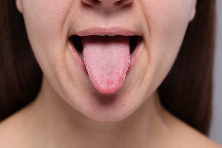 Closeup view of woman showing her tongueの写真素材
