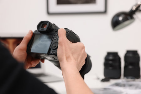 Professional photographer with digital camera indoors, closeupの写真素材