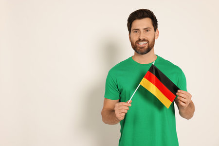 Man with flag of Germany on white background, space for textの写真素材
