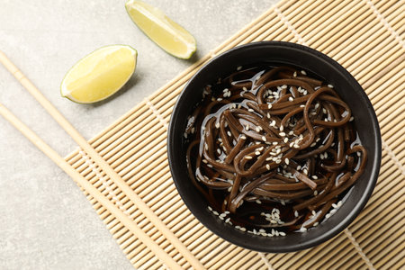 Tasty buckwheat noodles (soba) with sauce served on light table, flat layの写真素材