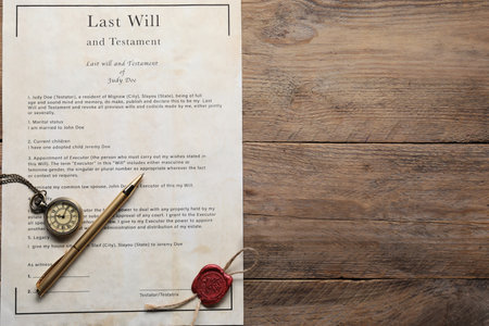 Last Will and Testament with wax seal, pocket watch and pen on wooden table, top view. Space for textの写真素材