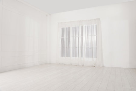 Empty room with white walls and large windowの写真素材