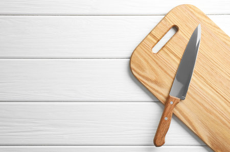 One sharp knife on white wooden table, top view. Space for textの写真素材