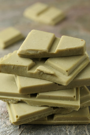 Stacked pieces of tasty matcha chocolate on textured table, closeupのeditorial素材
