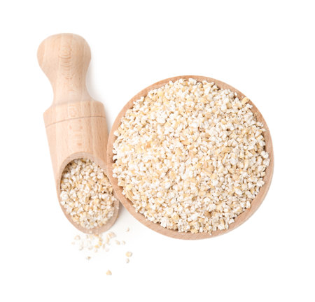 Raw barley groats in bowl and scoop isolated on white, top viewの写真素材