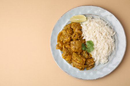 Delicious chicken curry with rice on beige background, top view. Space for textの写真素材