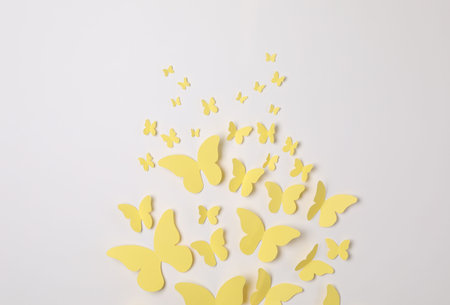 Yellow paper butterflies on white background, top viewの写真素材