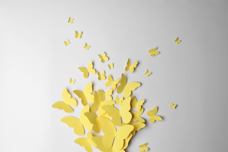 Yellow paper butterflies on white background, top viewの写真素材
