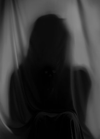 Silhouette of creepy ghost behind gray clothの写真素材