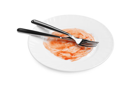 Dirty plate and cutlery on white backgroundの写真素材