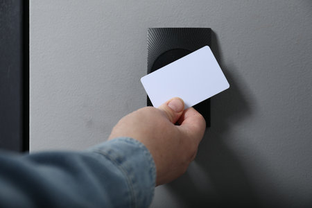 Man opening magnetic door lock with key card, closeup. Home security