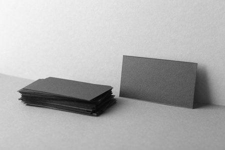 Blank black business cards on gray background. Mockup for designの写真素材