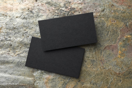 Blank business cards on stone background, top view. Mockup for designの写真素材