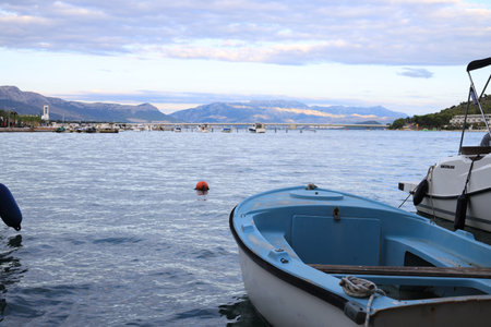Trogir, Croatia - September 24, 2023: Picturesque view of moored boats, mountains and sea on cloudy dayのeditorial素材