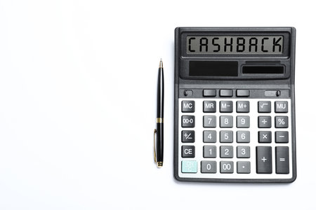 Calculator with word Cashback and pen on white background, top view. Space for textの写真素材