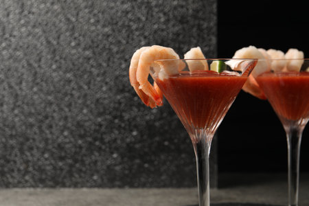 Tasty shrimp cocktail with sauce and lime in glasses on gray table, space for textの写真素材