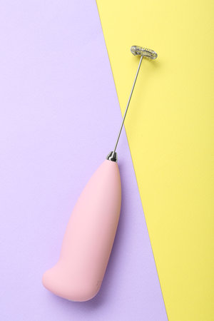 Pink milk frother wand on color background, top viewの写真素材