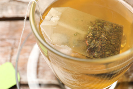 Tea bag in glass cup on table, closeupの写真素材