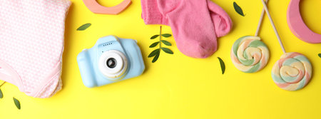 Flat lay composition with toy camera on yellow background, space for text. Future photographerの写真素材