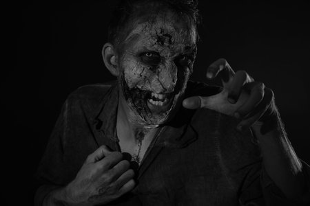 Scary zombie on dark background, black and white effect. Halloween monsterの写真素材