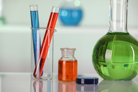 Laboratory analysis. Different glassware with liquids on white table against blurred background, closeupの写真素材
