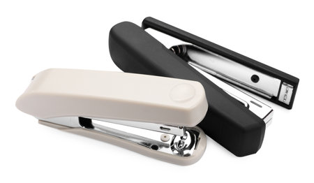Two new plastic staplers isolated on white