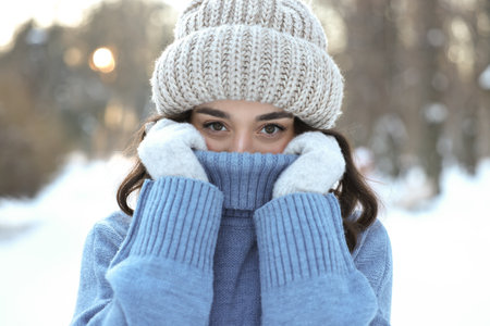 Portrait of young woman in snowy park
