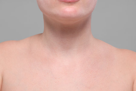 Closeup view of woman with normal skin on gray background