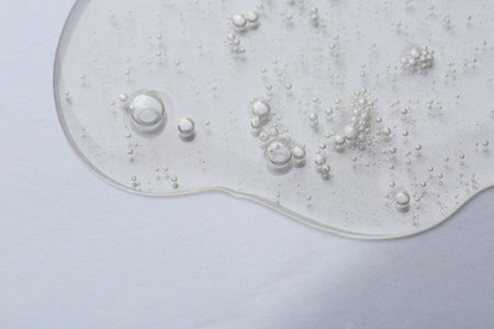 Clear cosmetic serum on white background, macro viewの写真素材