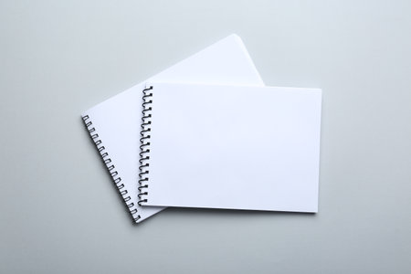 Notebooks on light gray background, top view. Space for textの写真素材