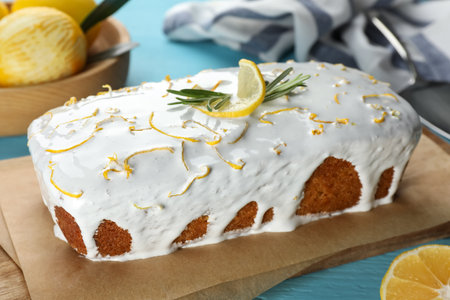 Tasty lemon cake with glaze on light blue wooden table, closeupの写真素材