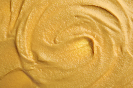 Fresh tasty mustard sauce as background, top viewの写真素材